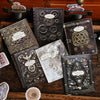 A collection of vintage alchemy metal-embossed decorative stickers and journal pages on a wooden surface.
