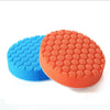 Two orange and blue car polishing sponge pads with hook-and-loop backing