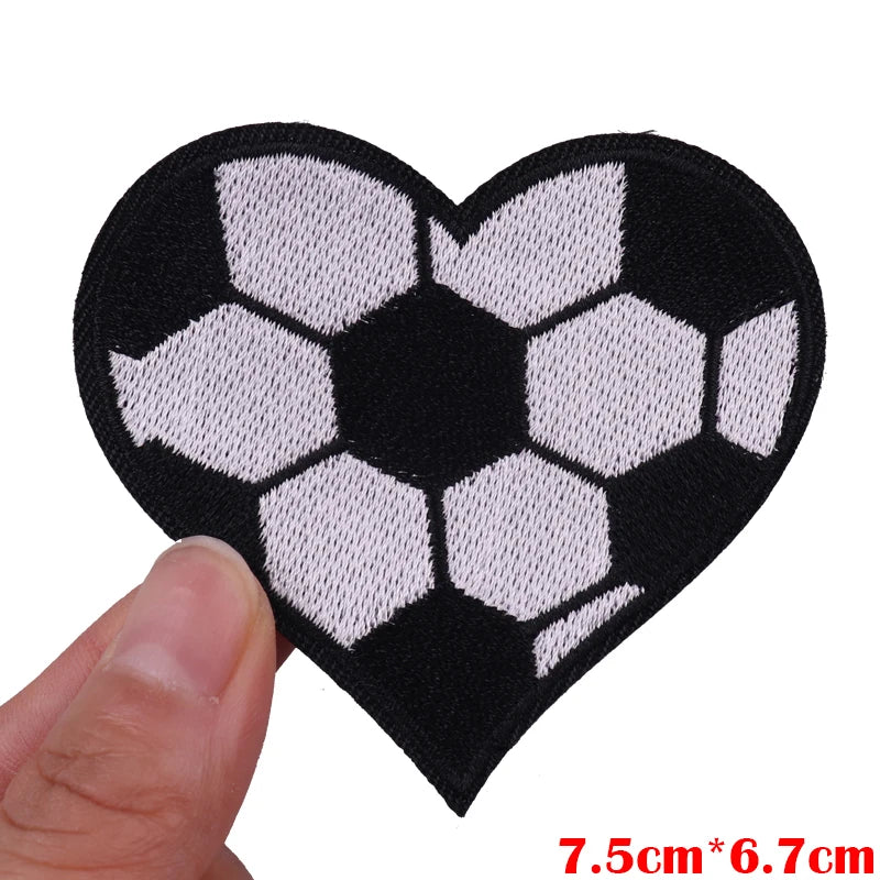 Black heart shaped iron-on patch featuring an embroidered soccer ball design in white and black.