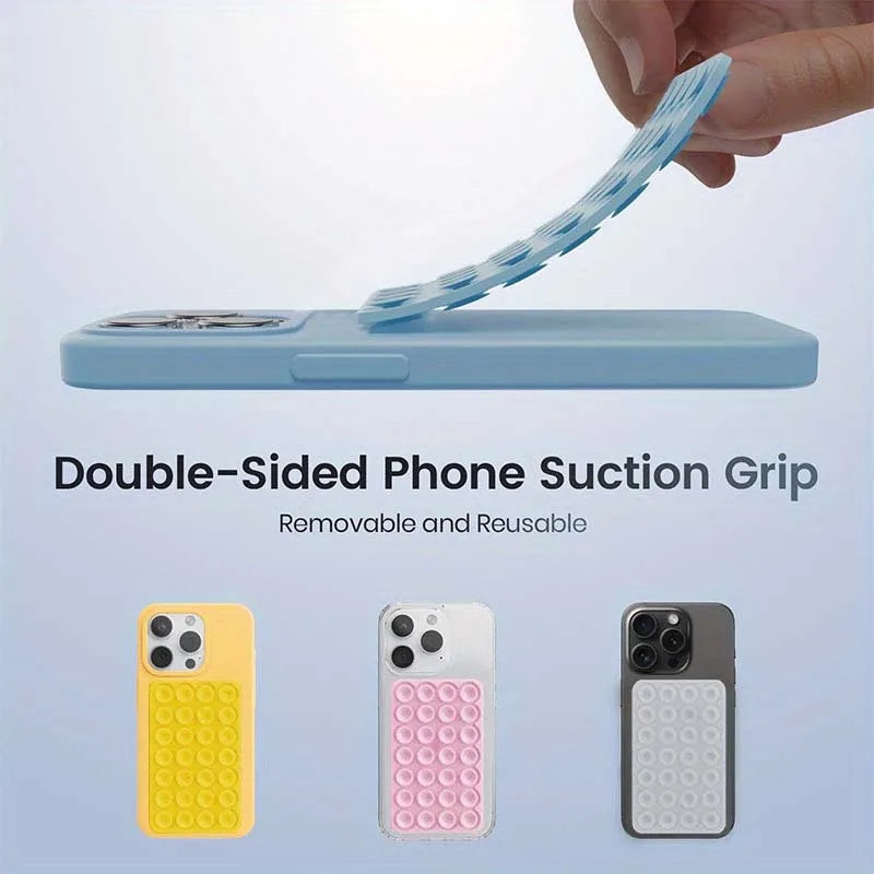 A hand is holding a blue double-sided phone suction grip, demonstrating its removable and reusable feature.