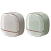 A modern, oval-shaped soap holder with a white and pale green color scheme.