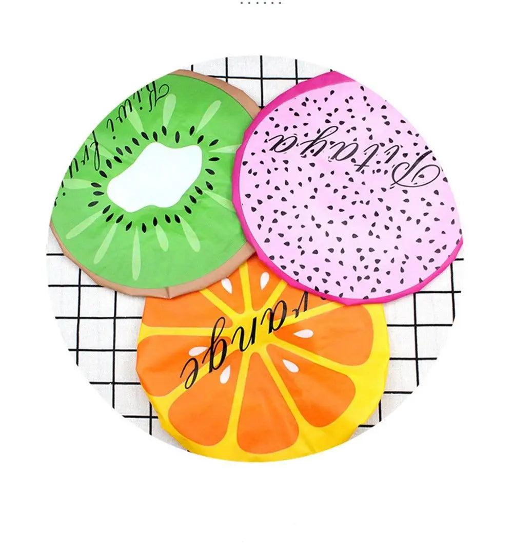Three fruit-themed waterproof shower caps featuring kiwi, watermelon, and orange designs.
