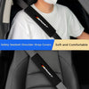 A close-up of a black seatbelt shoulder strap cover with the word ESPORT visible on a white t-shirt, shown in a car interior 