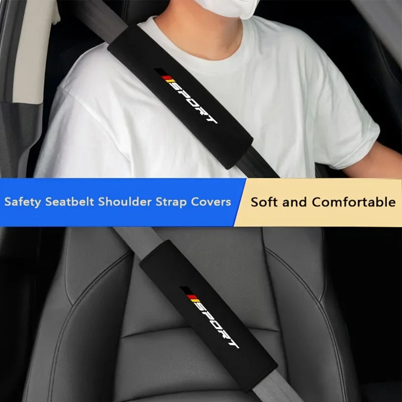 A close-up of a black seatbelt shoulder strap cover with the word ESPORT visible on a white t-shirt, shown in a car interior 