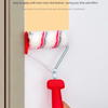 A hand is using a red paint edger roller with a white and red fuzzy lint roller to separate colors on a wall surface.