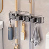 Wall-mounted metal holder for mop and broom with detachable hooks and measuring marks