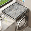 A silver washing machine with a floral print absorbent protective mat placed on the top surface.