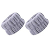 A pair of light gray absorbent microfiber wrist washing bands or face-saving cuffs.