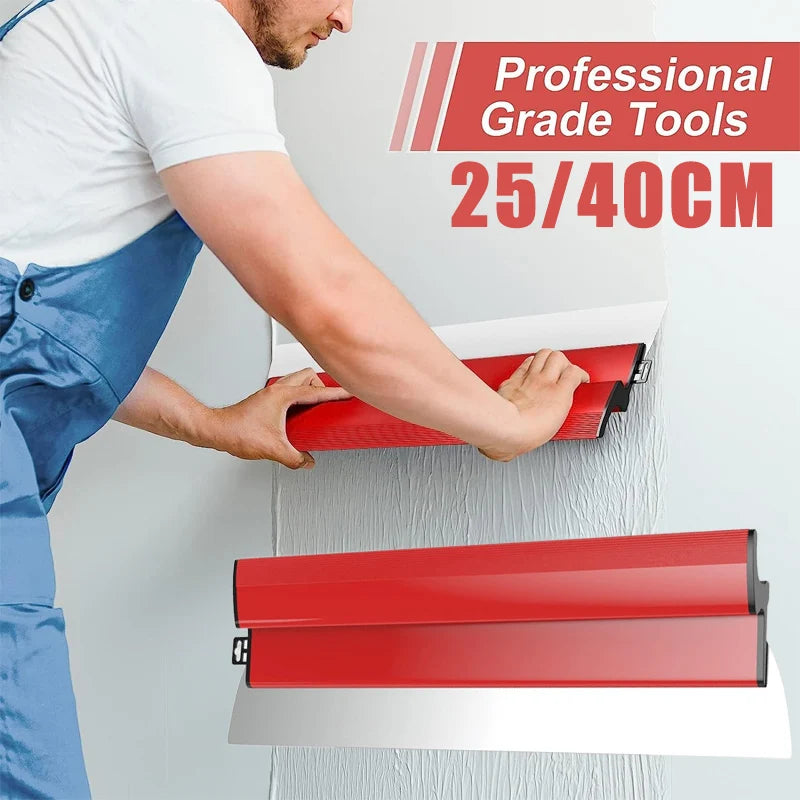 A person is using a professional grade skimming blade with a red handle to smooth a wall surface.