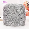 A ball of silver metallic silk crochet yarn used for knitting and macrame.