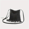 A black bohemian fringe shoulder bag with thin straps is displayed against a white background.