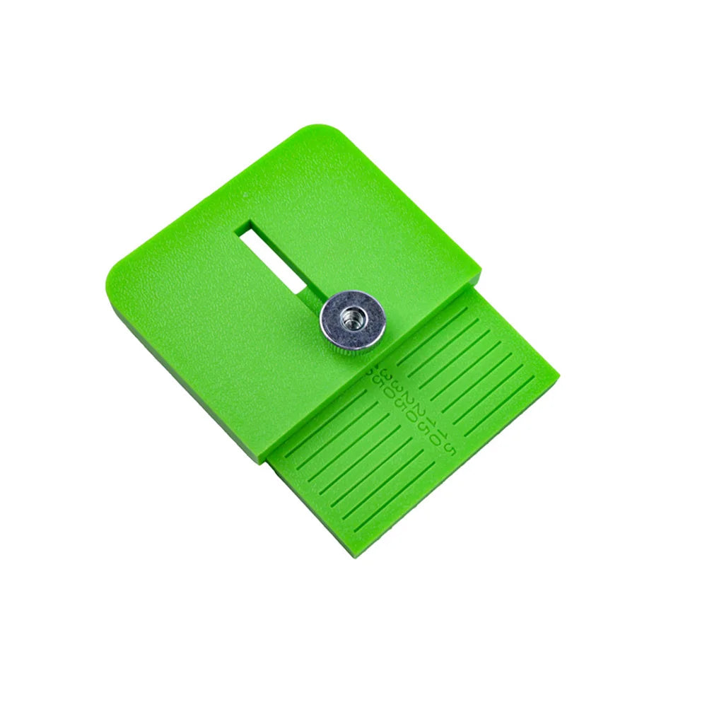 A bright green precision vinyl cutting tool featuring a measurement scale and a slot for a blade.