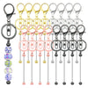 A collection of metal beadable keychain bars in various colors and finishes for DIY jewelry making.