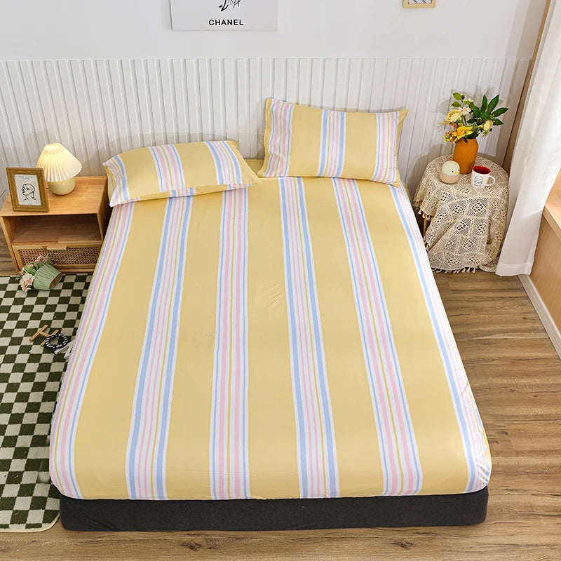 A yellow fitted bed sheet with vertical stripes in pastel colors is displayed on a bed.