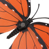 An orange monarch butterfly with black markings and antennae, used as a magnet or adhesive decor.