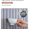 A hand holds a white ceramic cup against a gray striped wall panel, demonstrating high elastic shock absorption.