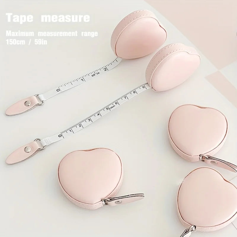 Pink PU leather tape measure shown next to heart-shaped pads for body measurements