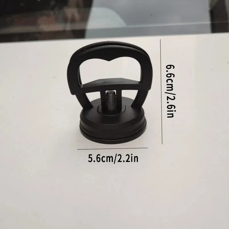 Black car dent puller kit with a handle lift and power remover tool shown on a white surface.