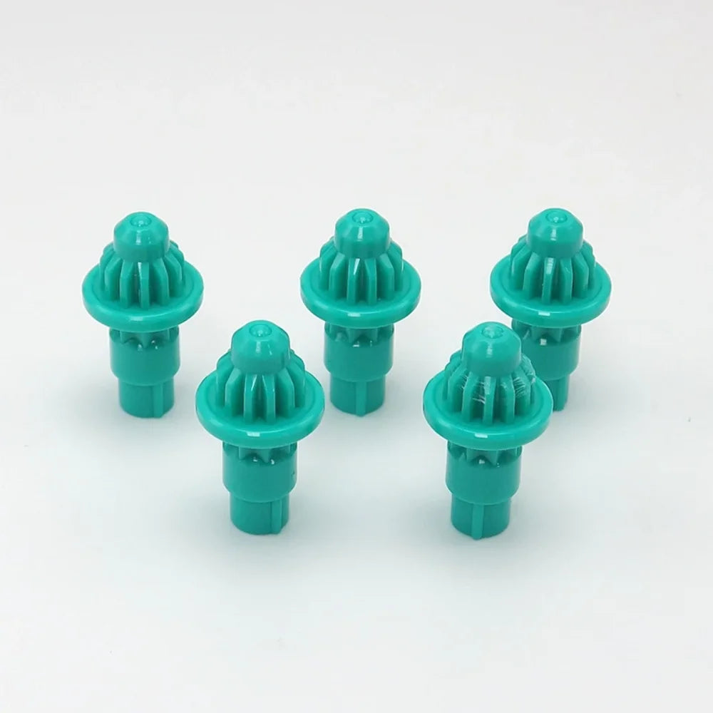 A set of five teal plastic replacement drivers for a battling top, packaged together.