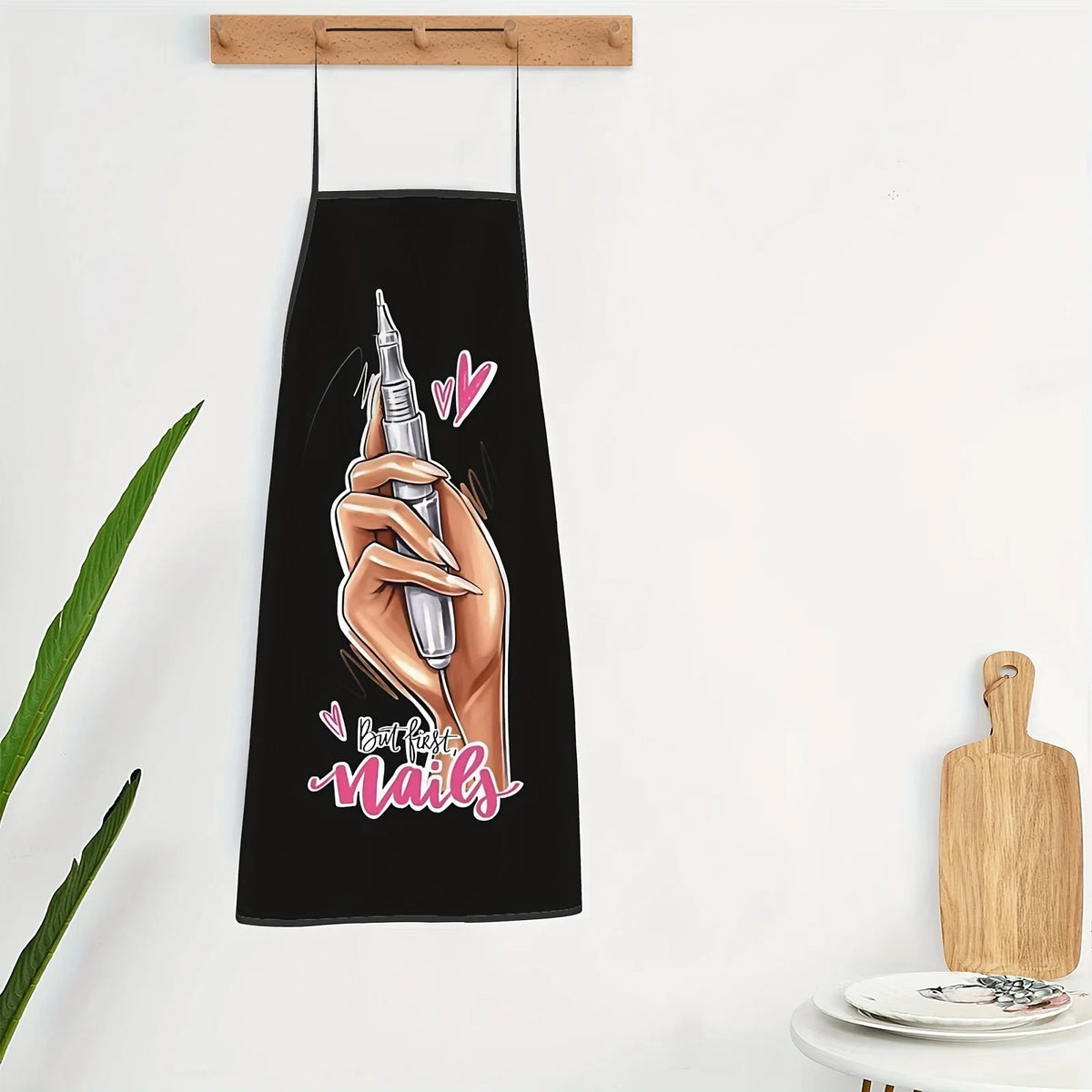Black apron featuring a graphic of a hand applying nail polish with the text Best Nails