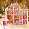 A pink dollhouse featuring a multi-story castle structure with various furniture and accessories for girls