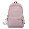 A pink waterproof nylon laptop backpack with a white bear charm