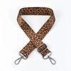 A brown leopard print wide adjustable crossbody bag strap.