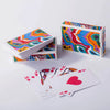 A colorful, portable deck of playing cards featuring a bold geometric pattern and the Balatro design.