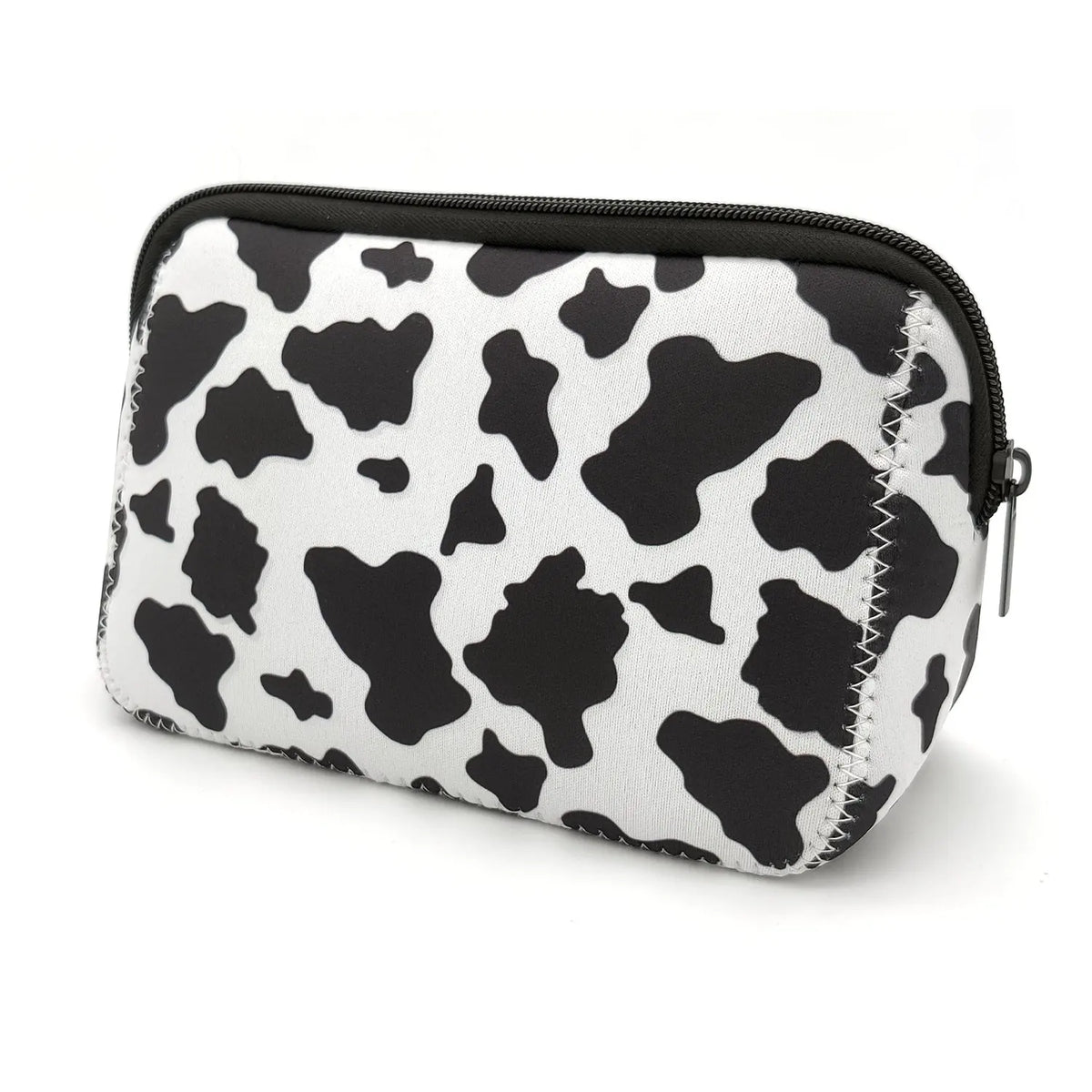 A black and white cow print cosmetic bag with a zipper, designed for travel makeup organization.