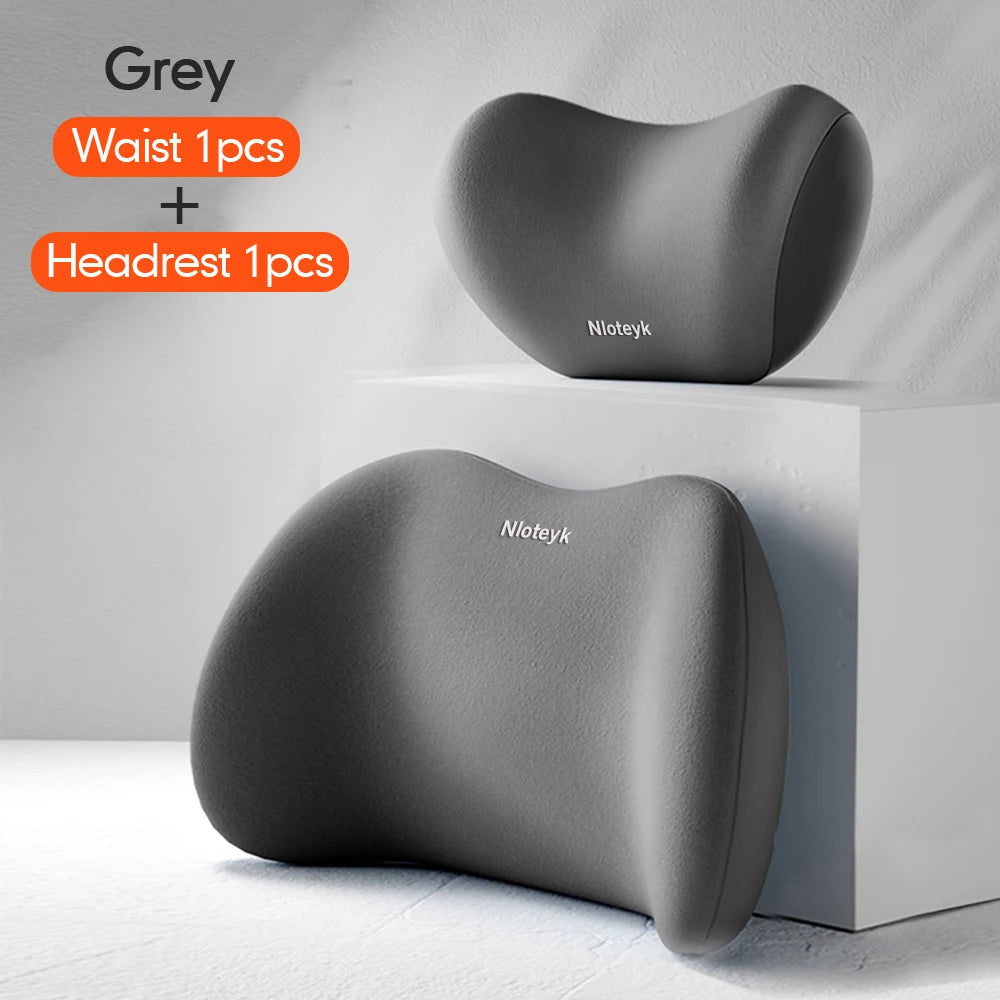Grey memory foam car headrest and lumbar support pillow shown on a white shelf.