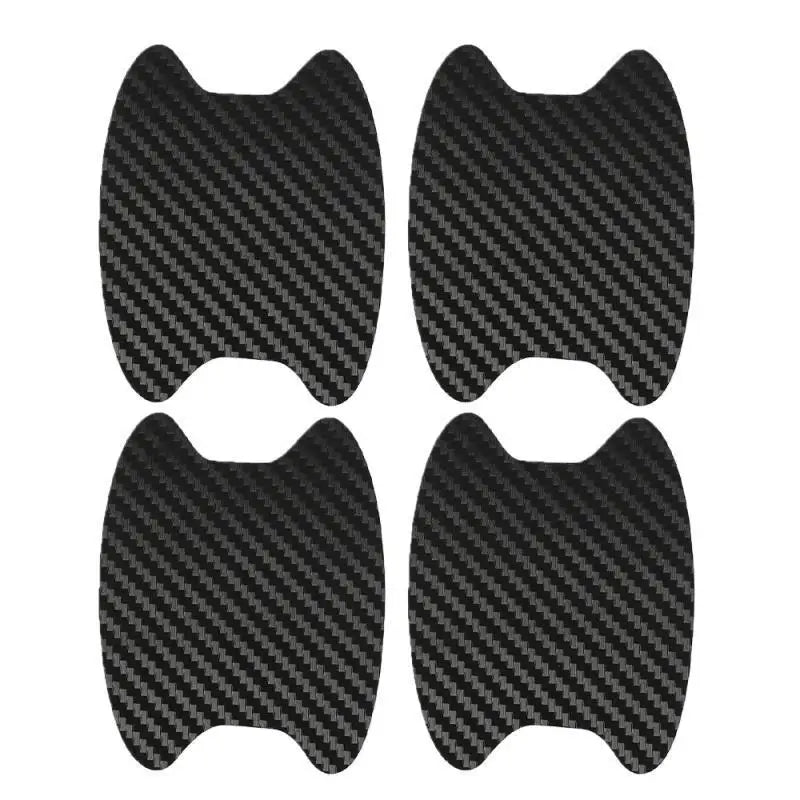 A set of four black carbon fiber protective covers for car door handles.