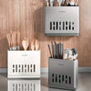 Three stainless steel cutlery organizers in silver and white tones displayed against a wooden background.