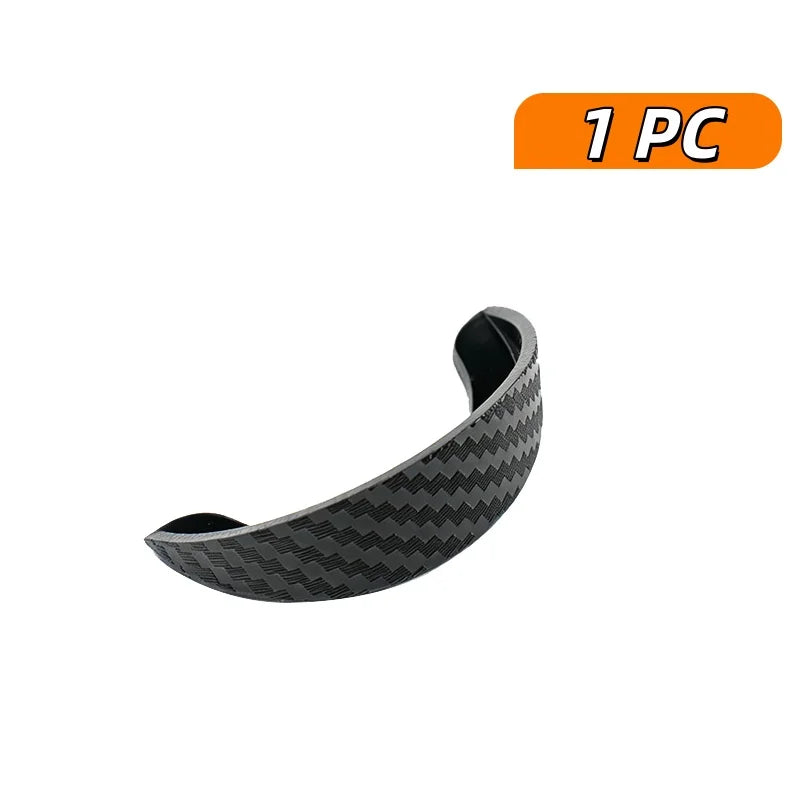 A single piece of carbon fiber rain cover for a car rear camera, designed to provide waterproof visor protection.