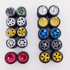 A collection of ten pairs of 1:64 scale alloy car wheels and tires in various colors and finishes.