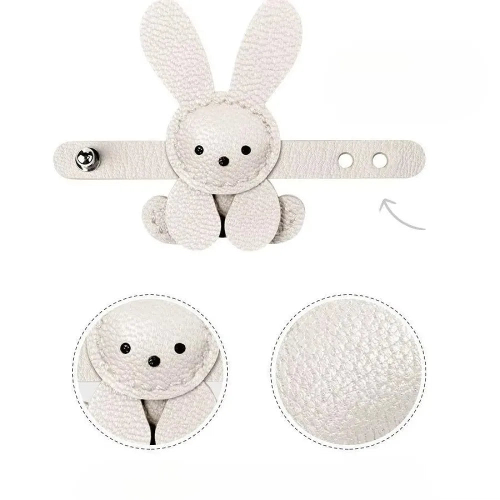 A white bunny bag charm keychain featuring a stitched rabbit design and a round white puff.
