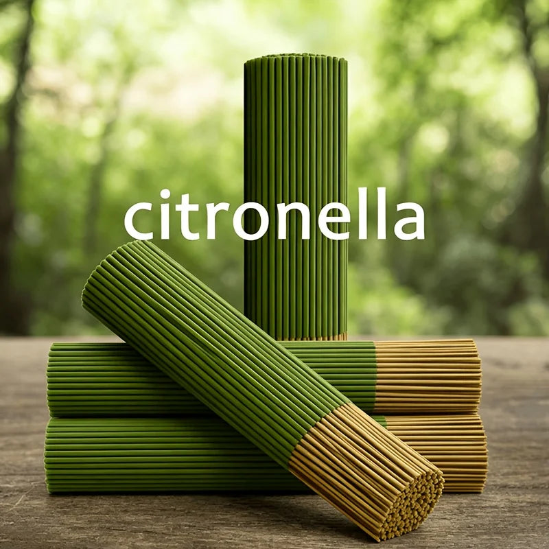 A stack of green citronella incense sticks, some lying horizontally on a wooden surface.
