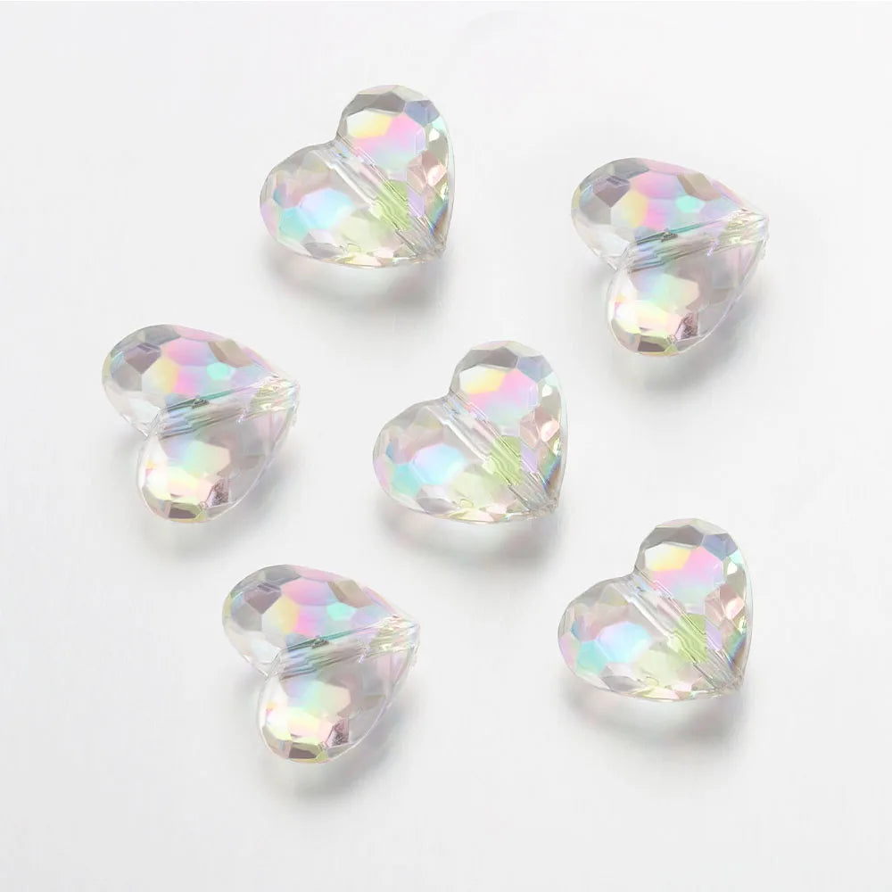A collection of twenty clear iridescent acrylic heart-shaped beads for jewelry making