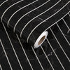 Roll of white peel-and-stick wallpaper featuring a black marble and white stripe pattern