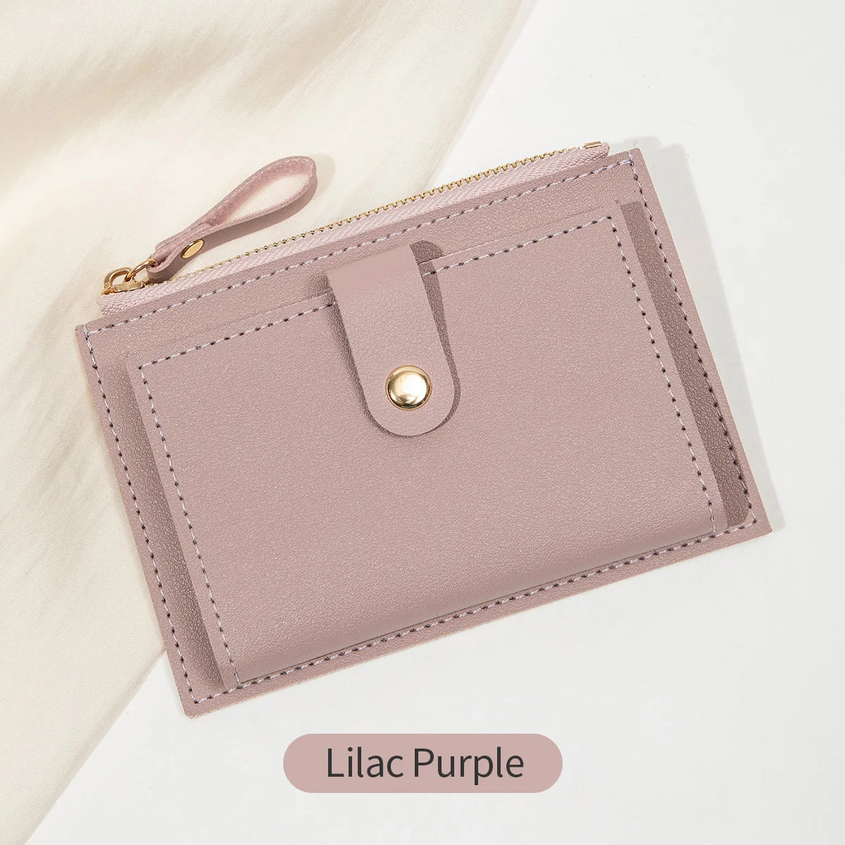 A light lilac purple women's slim PU leather card holder wallet with a gold zipper and stitched edges.