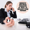 A woman is holding a black cell phone while working at a desk with soft foam sports stress balls visible nearby.