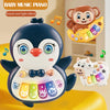 A black and white owl shaped musical piano toy with colorful buttons and light effects, next to a small monkey figure.