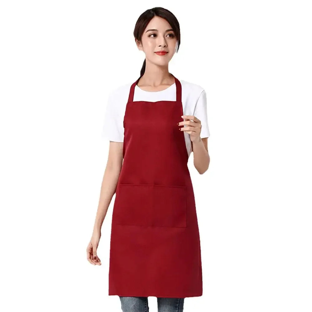 A woman wearing a maroon waterproof apron with a front pocket.