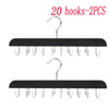 A set of 20 black hooks for hanging belts, hats, and accessories.