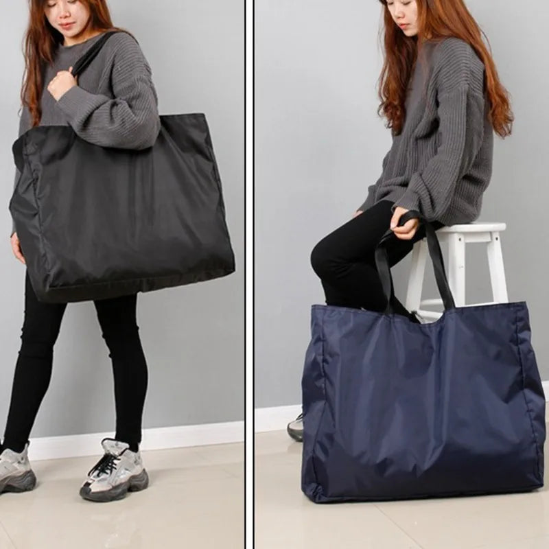 A woman is holding a dark gray reusable large-capacity grocery tote bag.