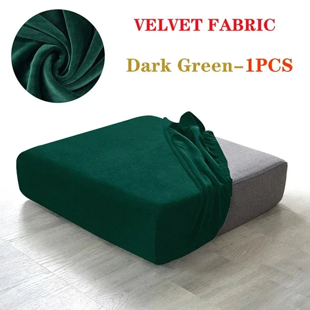 Dark green velvet fabric sofa cover in a draped style shown on a light wooden floor.