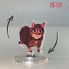 Two acrylic ornaments of a cat in motion on a clear circular base