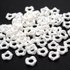 A pile of white acrylic pearl spacer beads for jewelry making