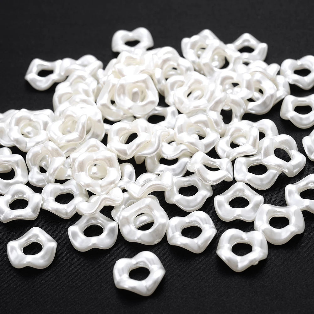 A pile of white acrylic pearl spacer beads for jewelry making