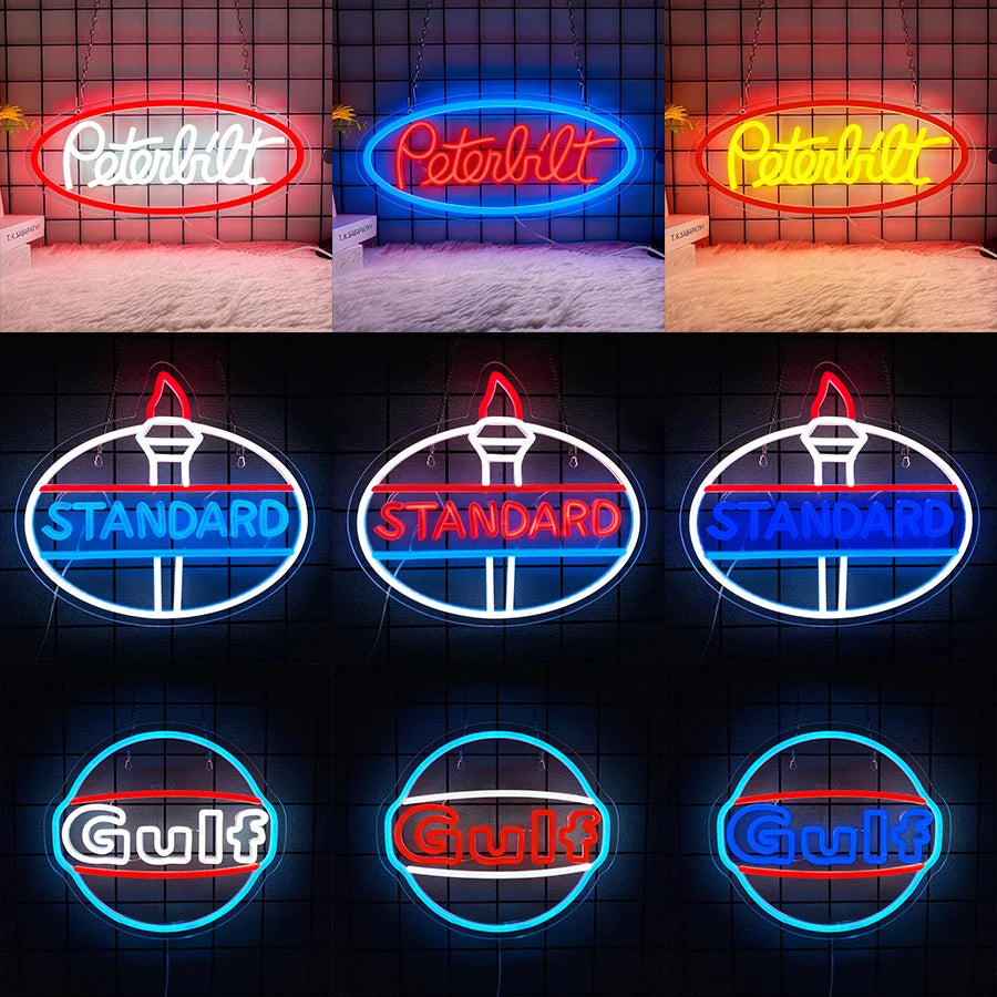 A collection of neon signs featuring the Peterbilt truck logo and the Gulf oil company name.