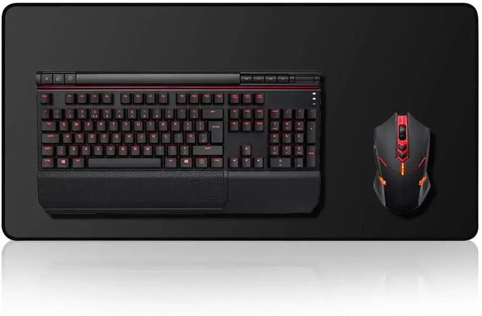 A black mechanical keyboard and an orange gaming mouse are displayed on a black desk mat.